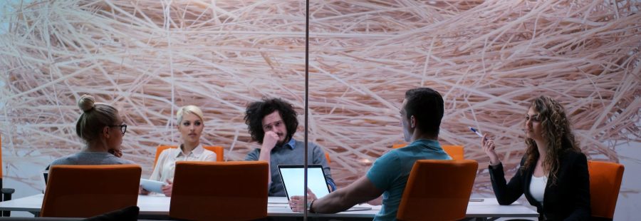 Group of a young business people discussing business plan at modern startup office building